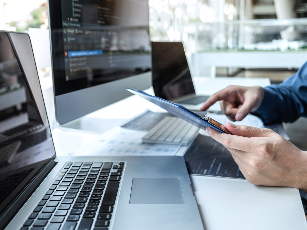 Developer programmer working on project in software development computer in IT company office, Writing codes and data code website and coding database technologies to find solution to problem.